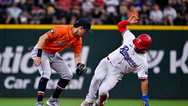 Jul 3, 2023; Arlington, Texas, USA; Texas Rangers second baseman Marcus Semien (2) steals second base against Houston Astros shortstop Mauricio Dubon (14) during the third inning at Globe Life Field. Mandatory Credit: Jerome Miron-USA TODAY Sports